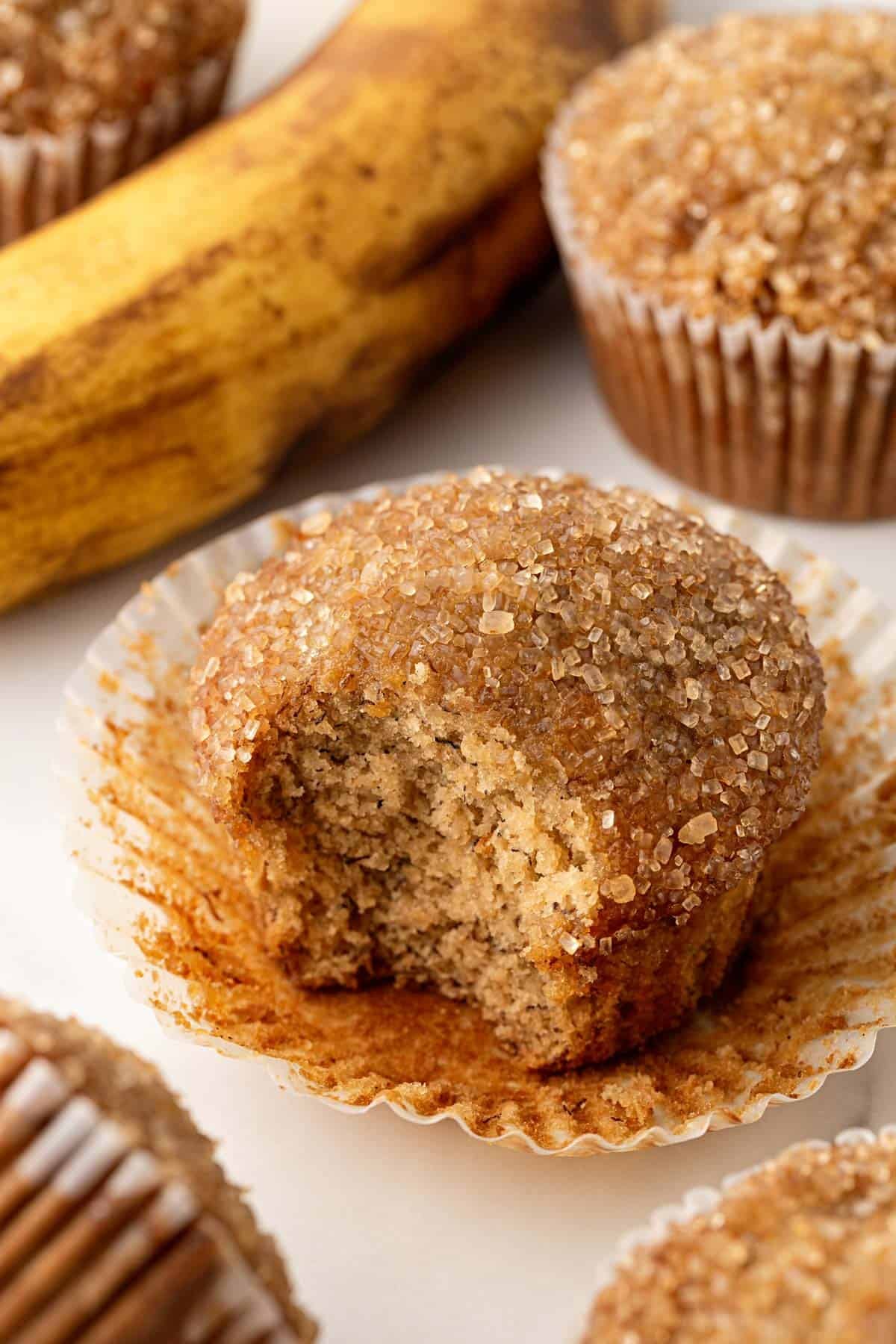 Banana muffin with a bite taken out, showing the moist crumb
