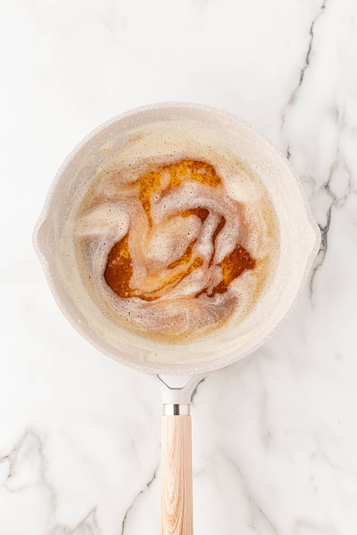 Brown butter foaming in a small saucepan