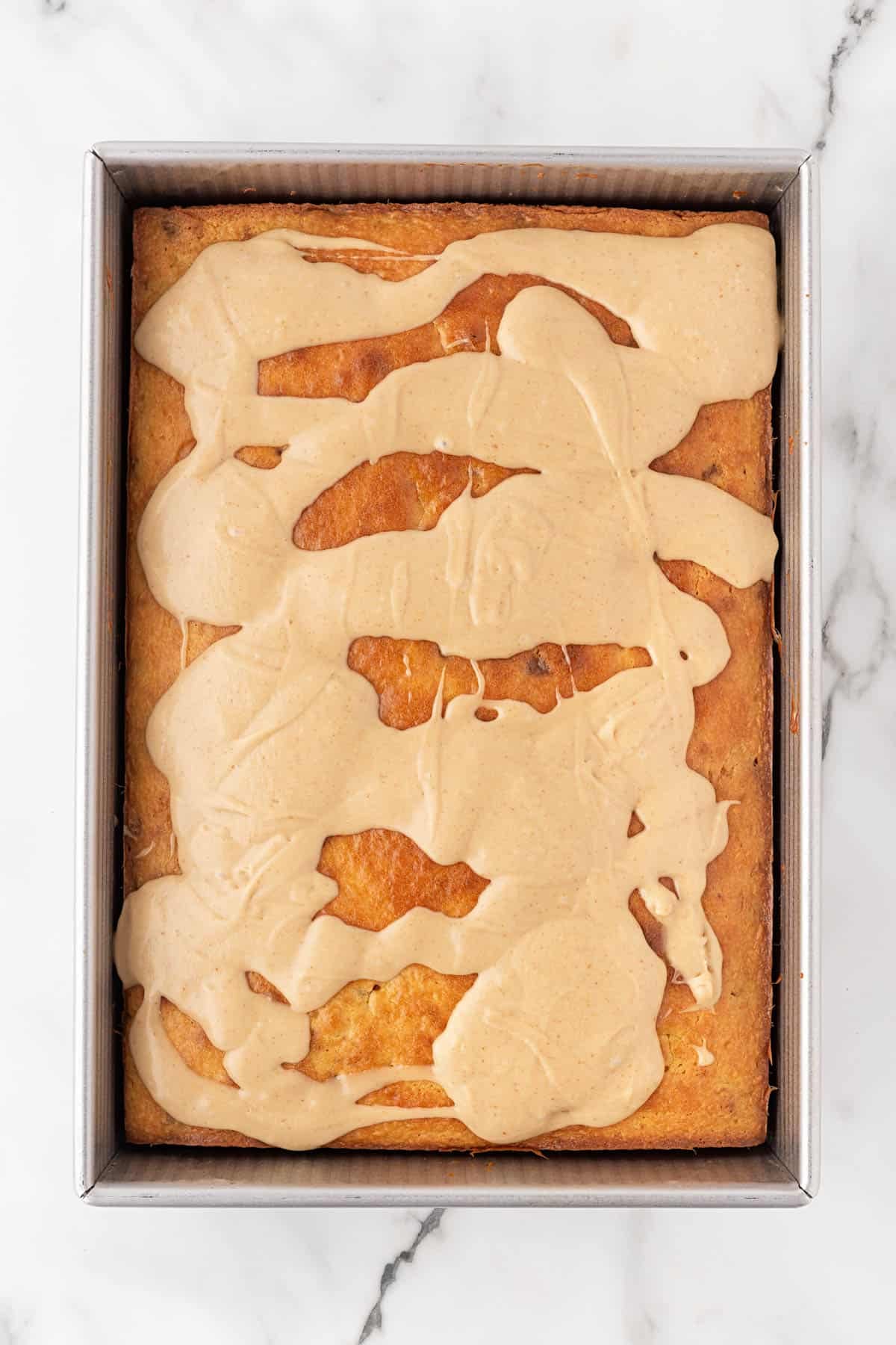 Cookie butter glaze spread over warm Biscoff honey bun cake