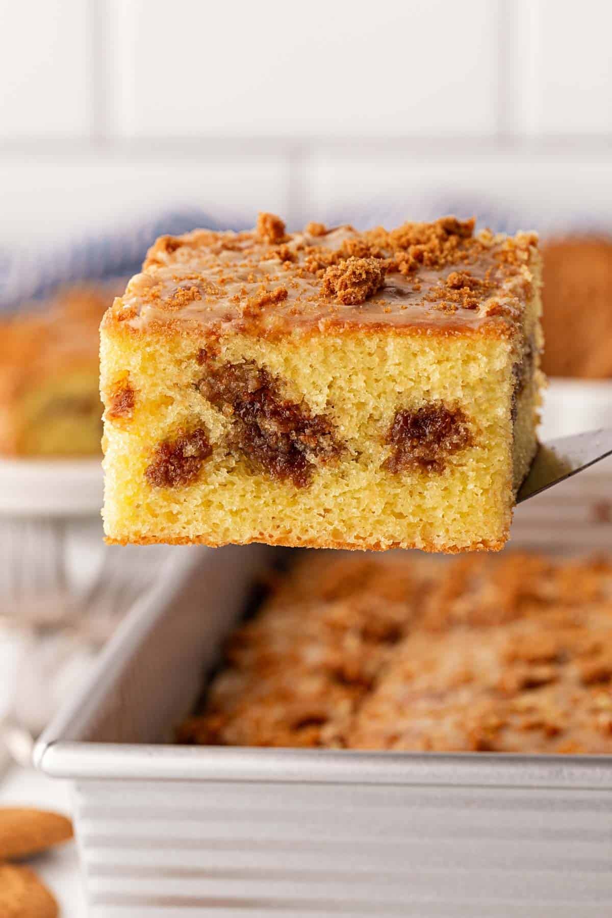 Slice of Biscoff honey bun cake lifted from the baking pan