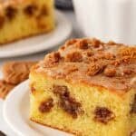 Closeup of slice of Biscoff honey bun cake with cookie butter glaze and Biscoff crumbs