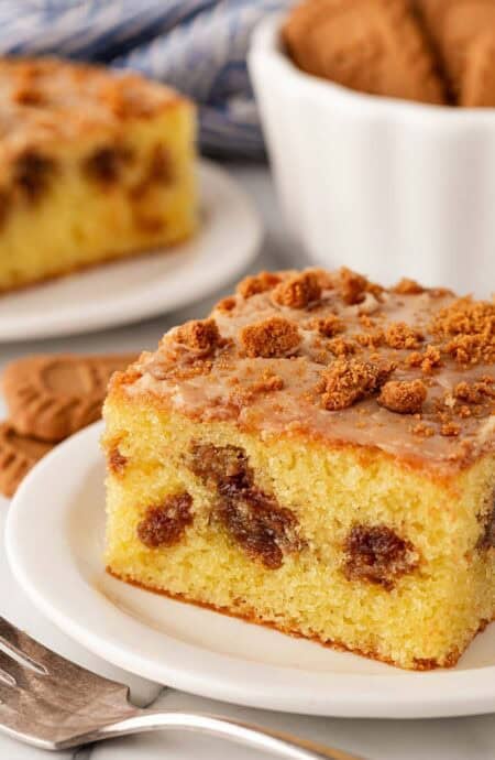 Closeup of slice of Biscoff honey bun cake with cookie butter glaze and Biscoff crumbs