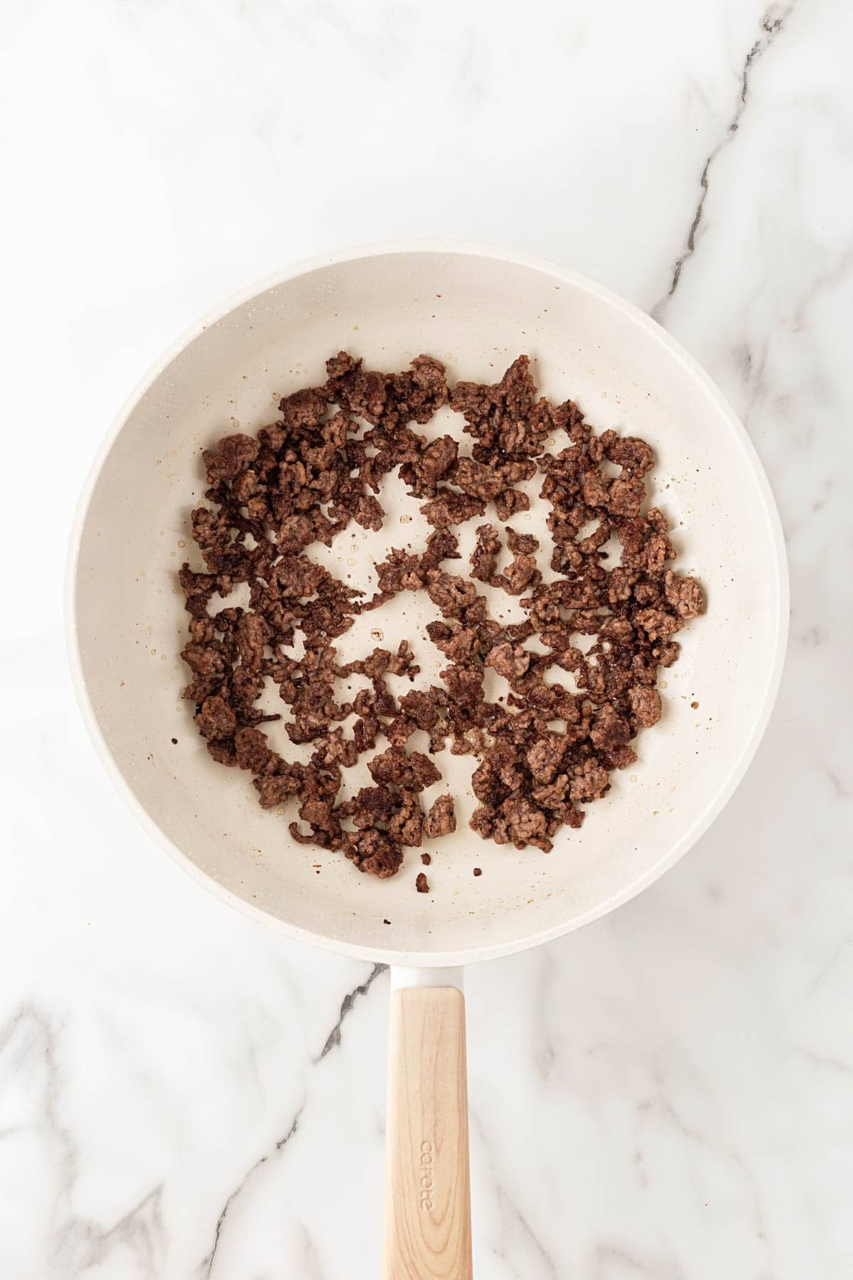 Ground beef browned and crumbled in a skillet