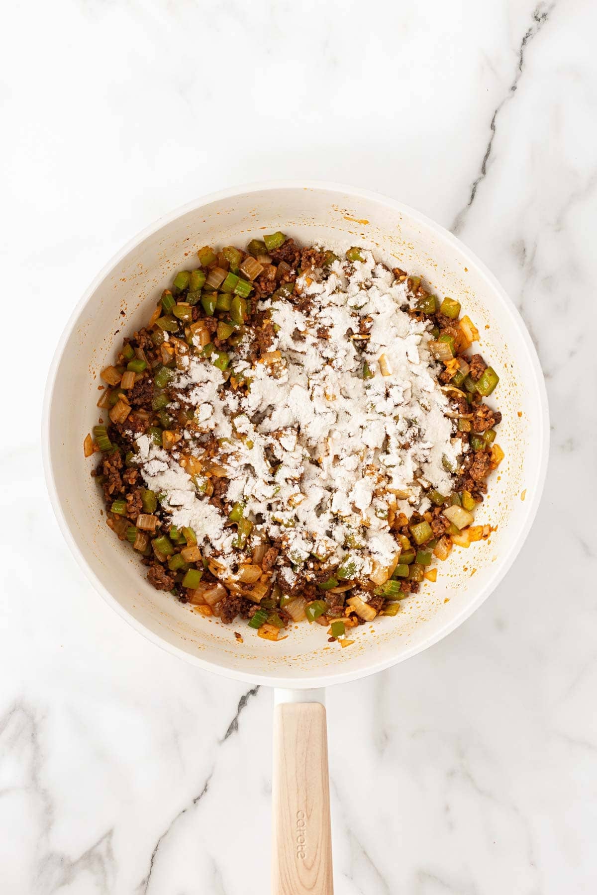 Flour sprinkled over the ground beef and vegetable mixture
