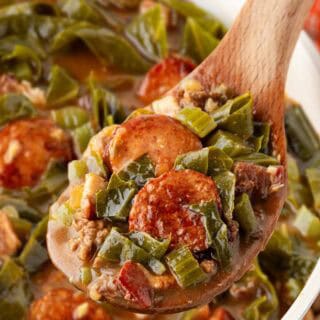 Spoonful of dirty greens with collards, andouille sausage, ground beef, and bacon