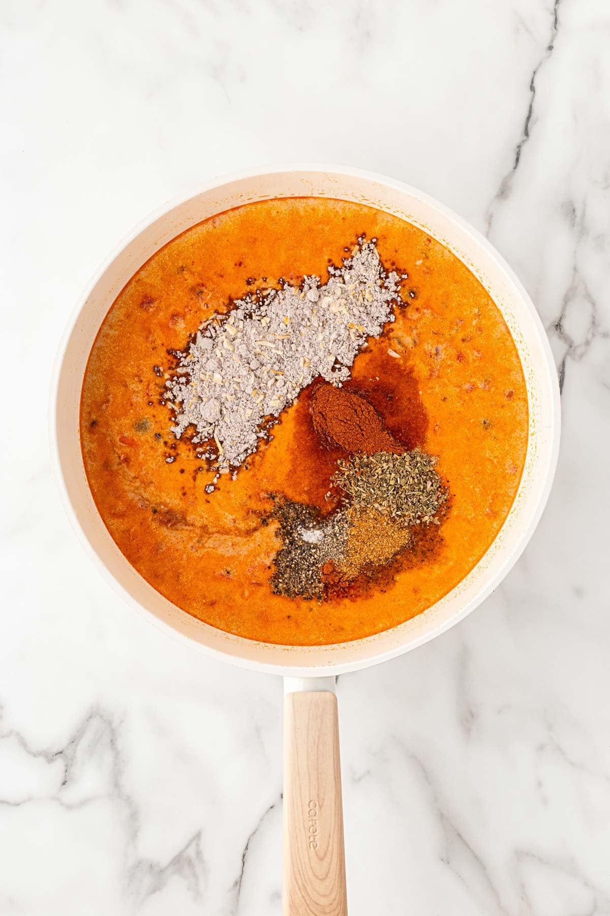Creamy tomato meat sauce topped with onion soup mix, Cajun seasoning, Italian seasoning, and spices