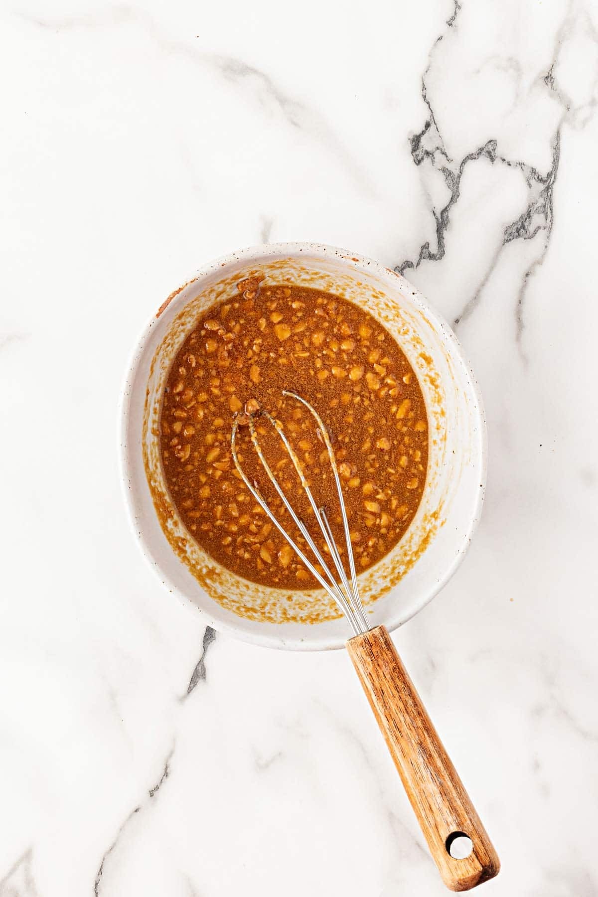 Peanut butter, maple syrup, and soy sauce mixture whisked together in a bowl
