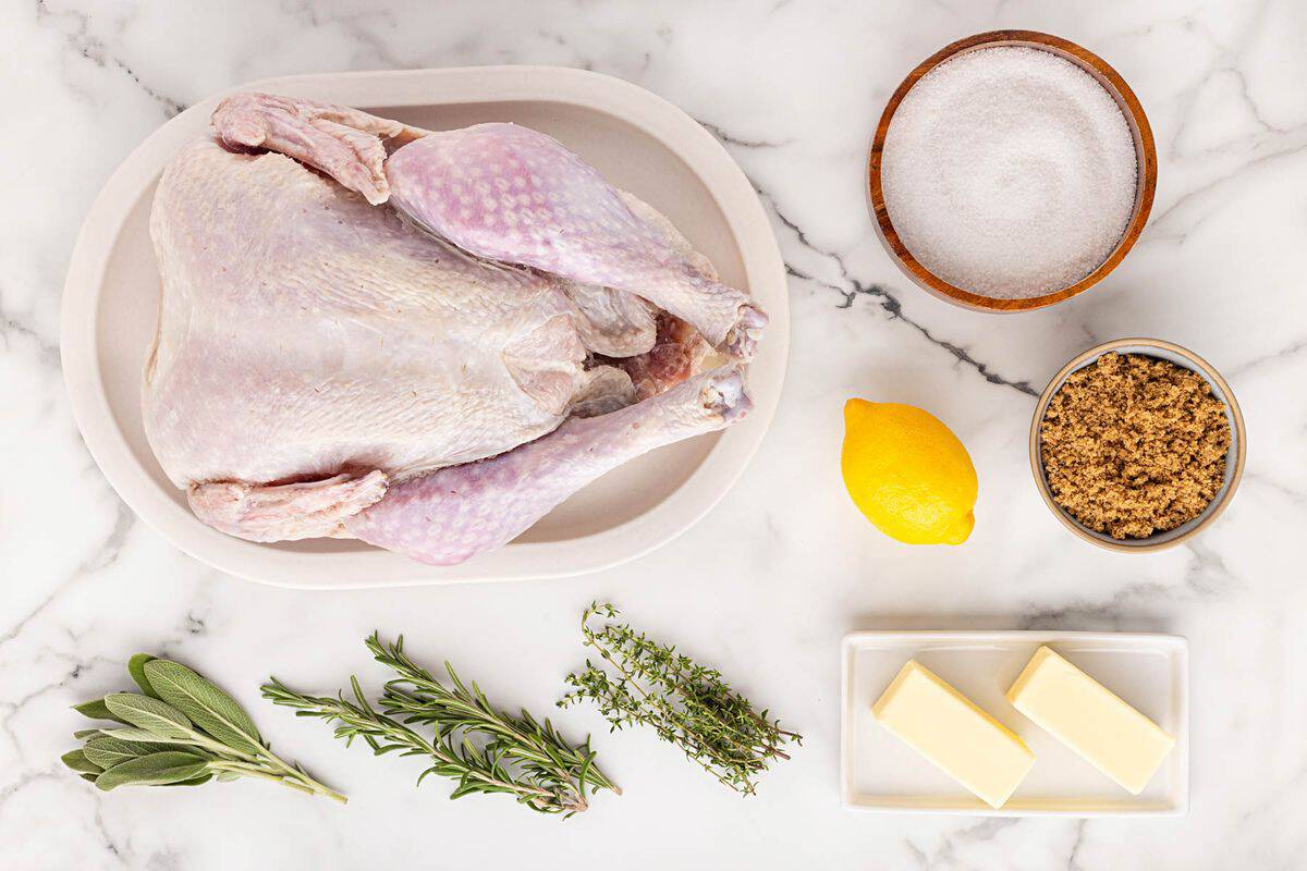 Overhead shot of ingredients for making oven roasted turkey sitting on a marble surface