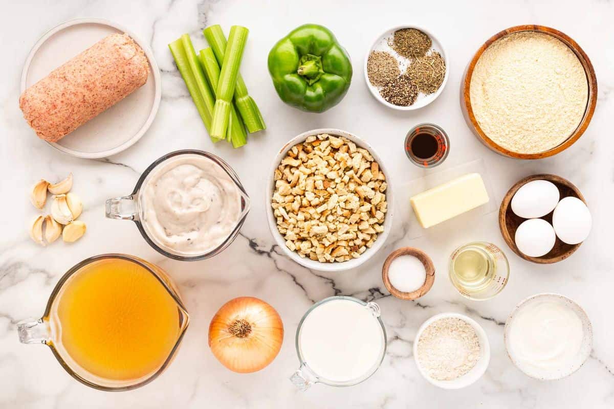 Overhead shot of ingredients for making sausage cornbread dressing on a marble surface