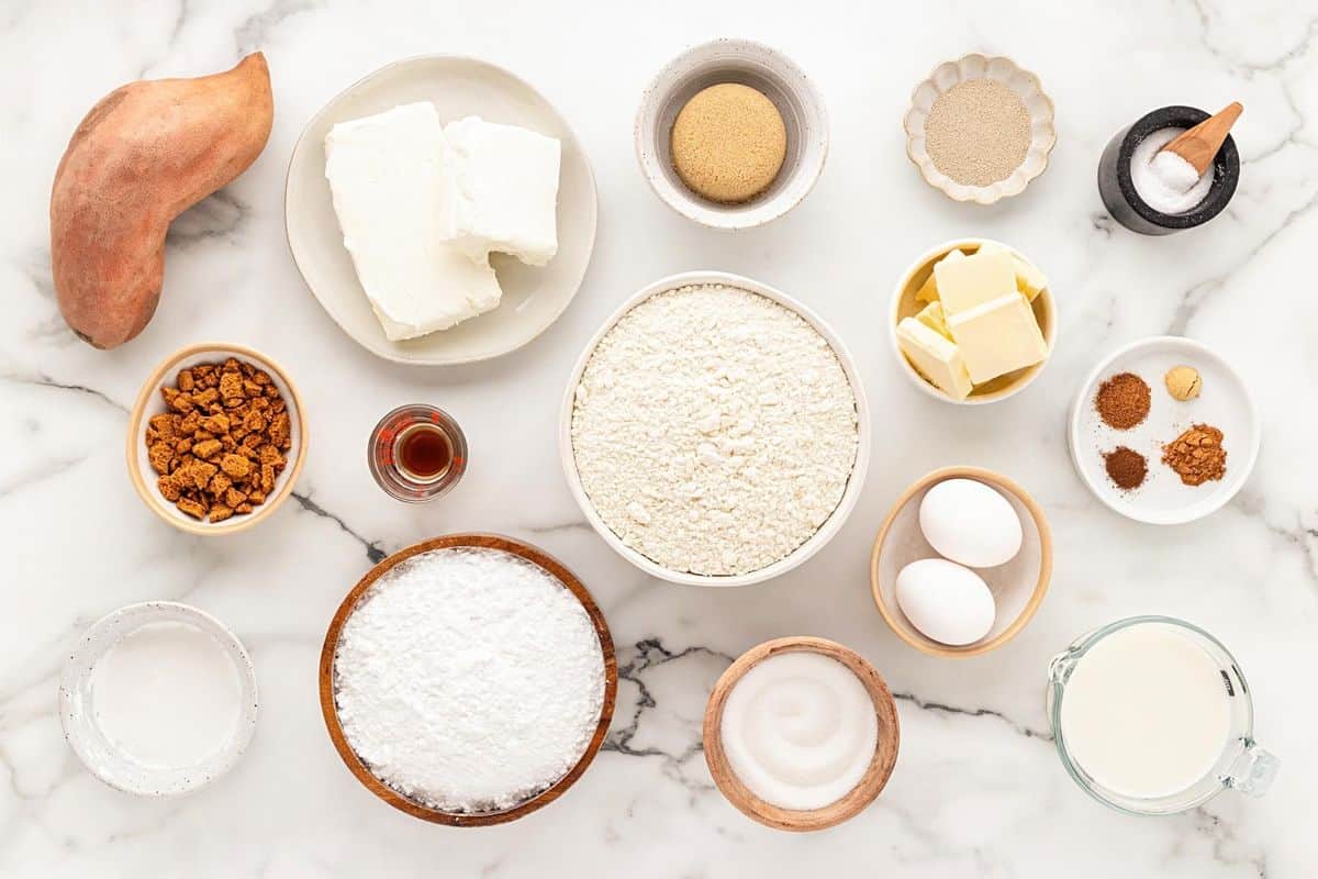 Sweet potato pie cinnamon roll ingredients on a marble surface