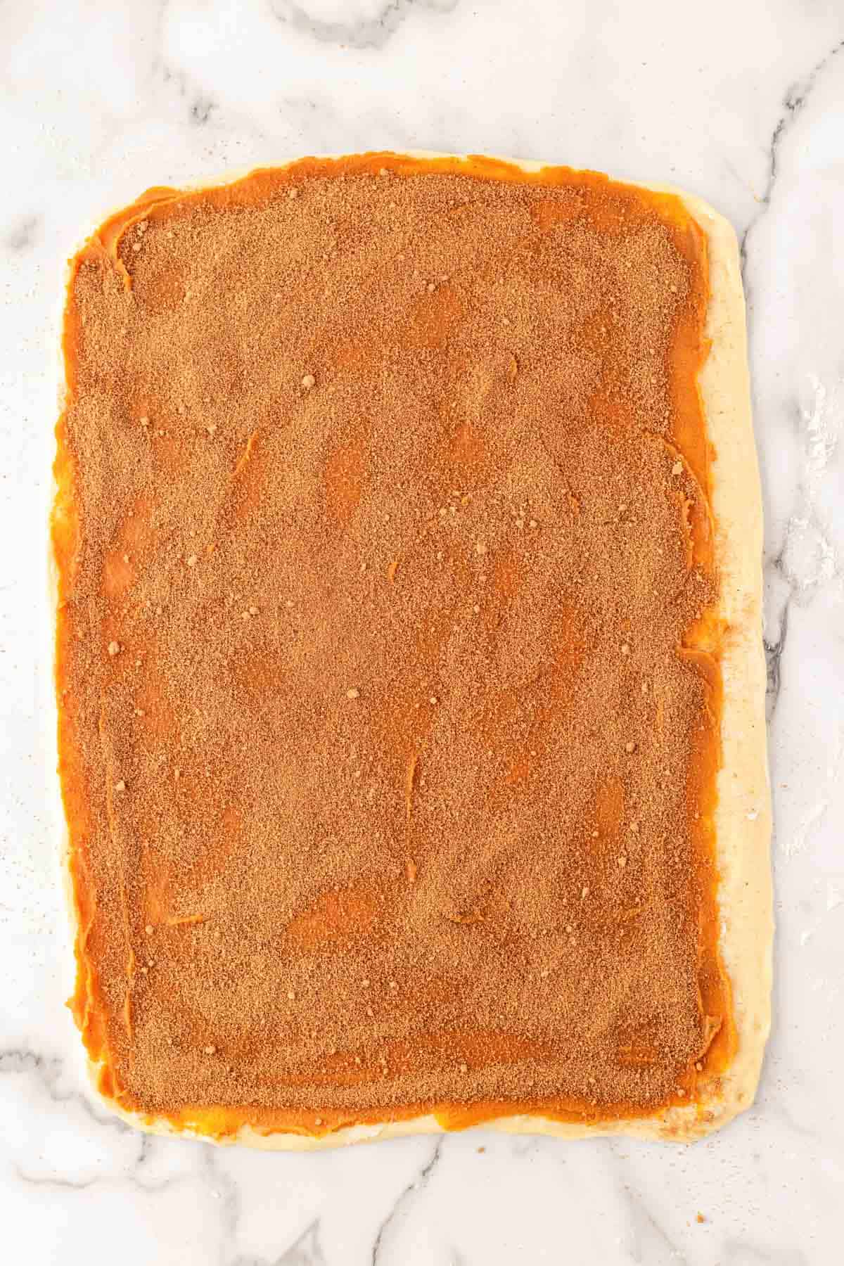 Rolled dough topped with sweet potato filling and brown sugar spice mixture